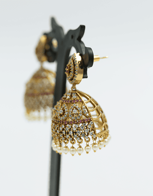 Gold Toned Jhumka Earrings with Purple Accents