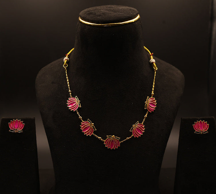 Jewelry set with necklace and earrings on a black mannequin against a dark background