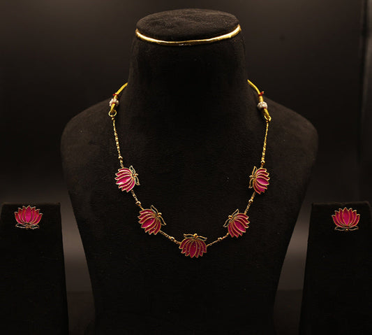 Jewelry set with necklace and earrings on a black mannequin against a dark background