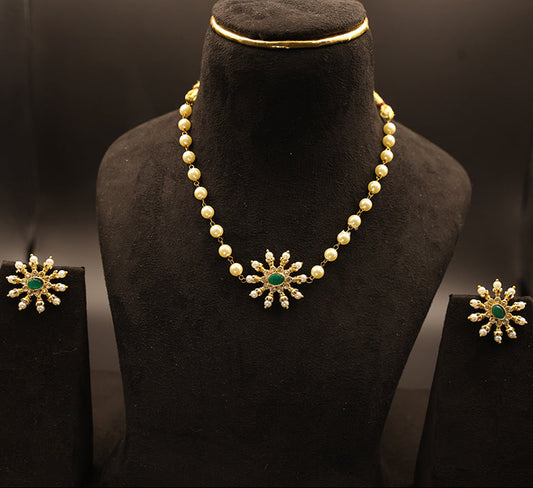 Jewelry set with necklace and earrings on a black mannequin bust.