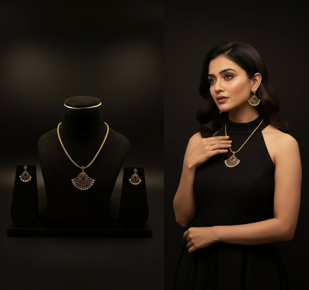 a gold plated necklace with a stone pendent 