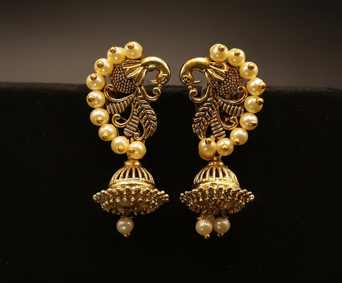antique gold-toned Jhumka earrings with a peacock stud adorned with pearls
